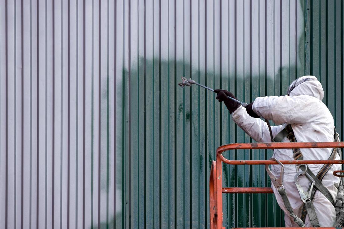 worker painting the commercial building
